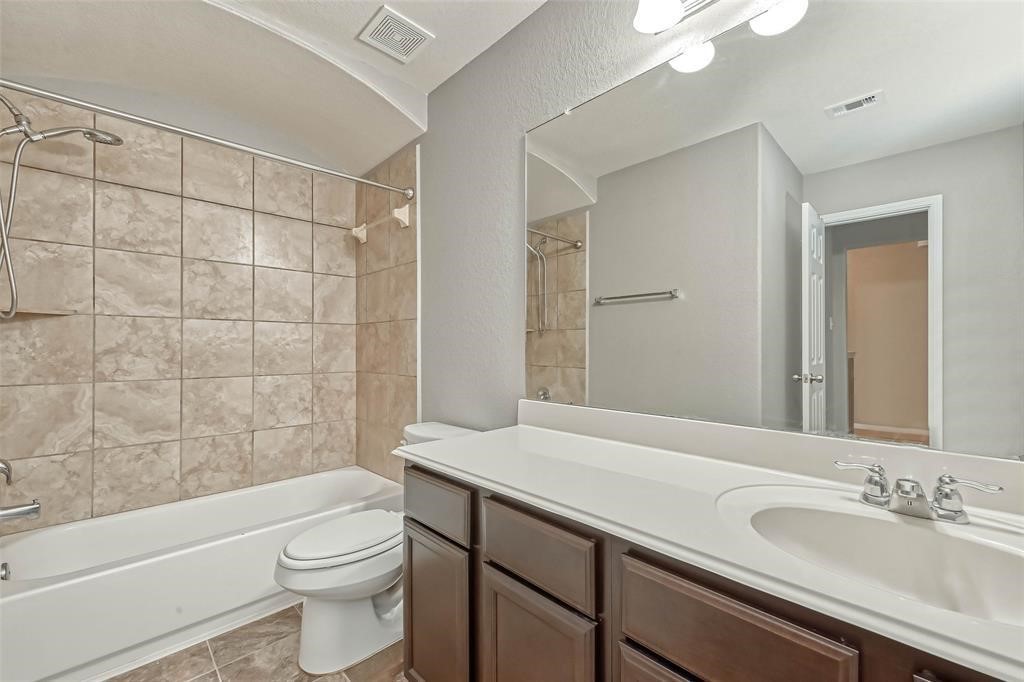 2561 Magnolia Fair Way Spring, TX 77386 - Photo 20 of 35 a bathroom with a sink a toilet and shower