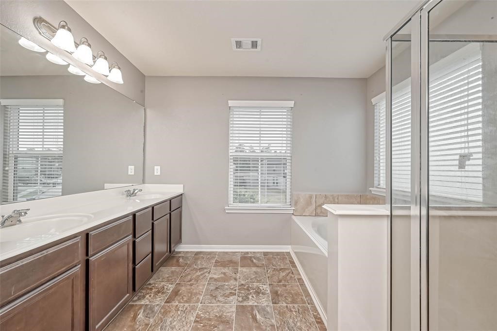 2561 Magnolia Fair Way Spring, TX 77386 - Photo 25 of 35 a bathroom with a tub sink and mirror