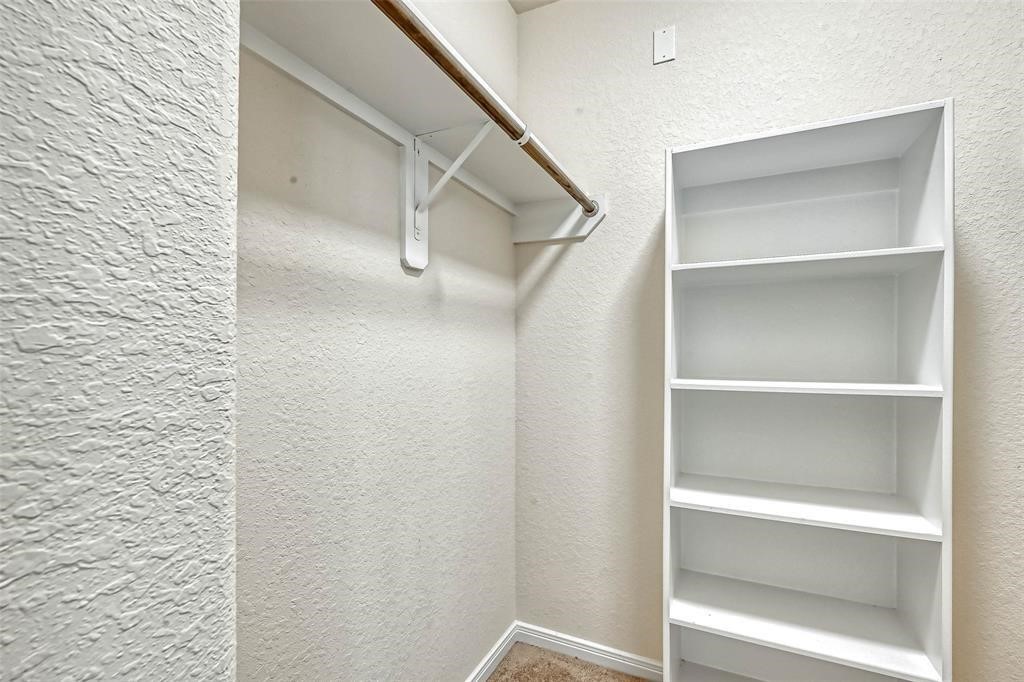 2561 Magnolia Fair Way Spring, TX 77386 - Photo 29 of 35 a view of walk in closet with empty racks