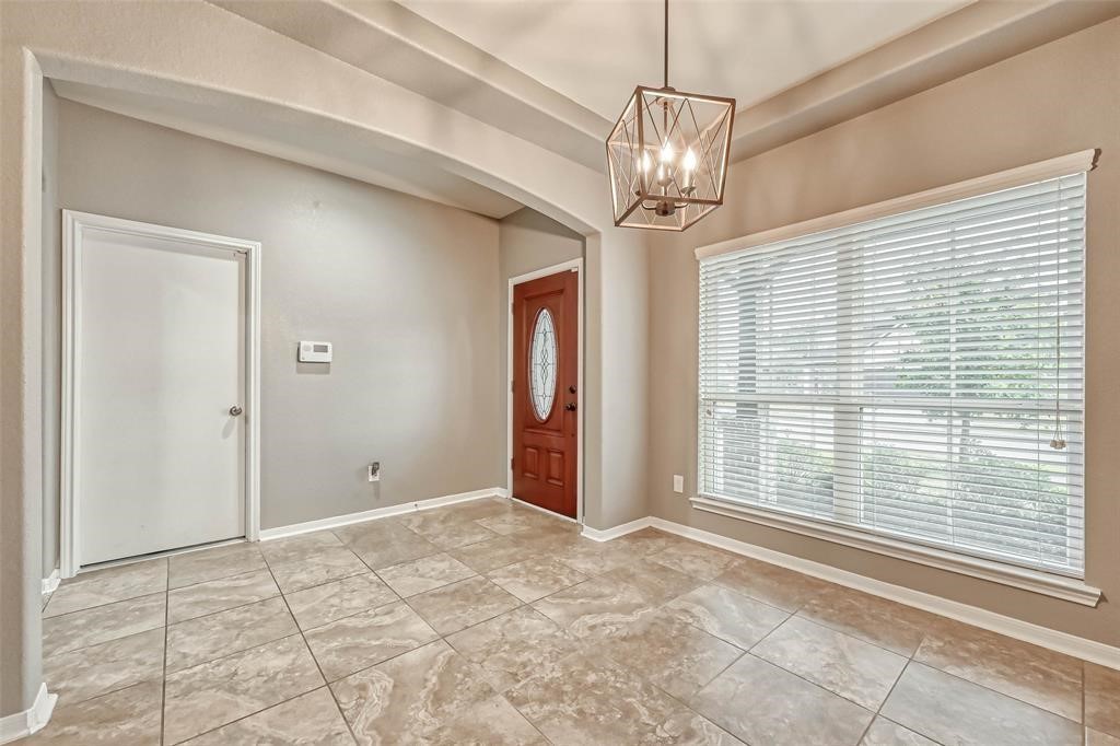 2561 Magnolia Fair Way Spring, TX 77386 - Photo 5 of 35 a view of a livingroom with a chandelier fan and windows