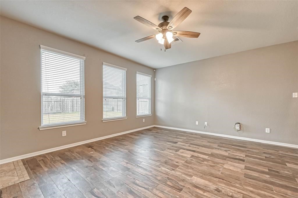 2561 Magnolia Fair Way Spring, TX 77386 - Photo 8 of 35 an empty room with chandelier fan and windows