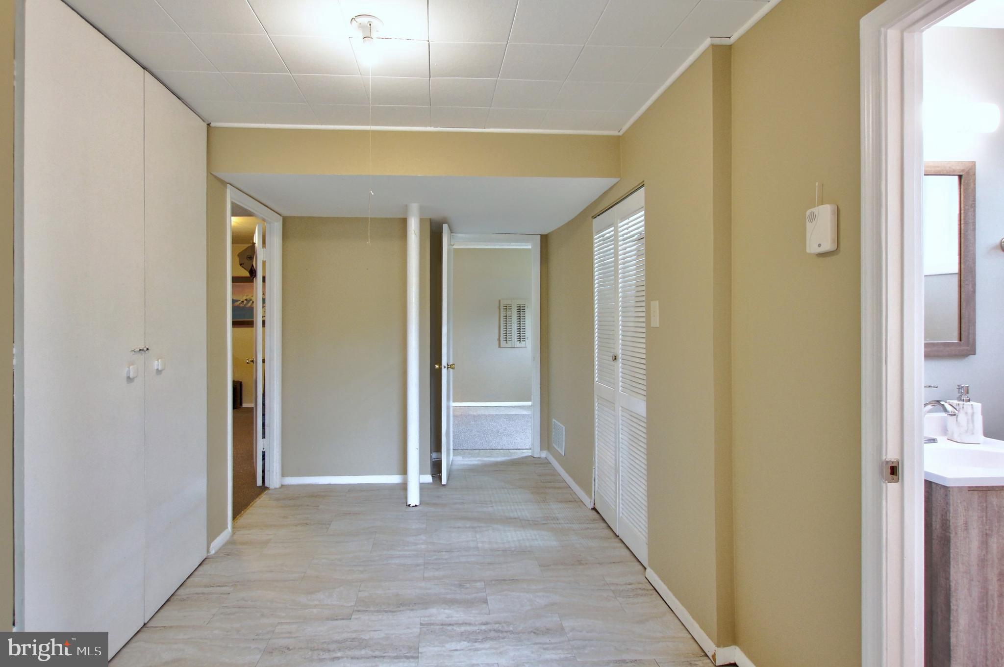 14105 Adkins Road Laurel, MD 20708 - Photo 24 of 36 Lower level hall w/ laminate flooring