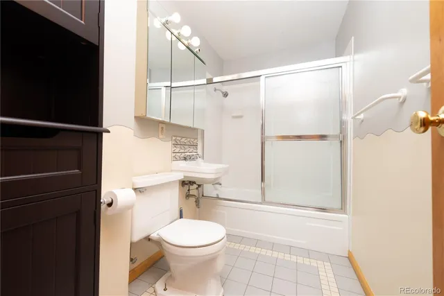 a bathroom with a toilet a sink and a shower