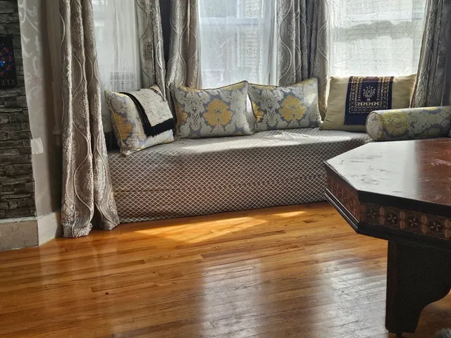 a view of a couch in wooden floor