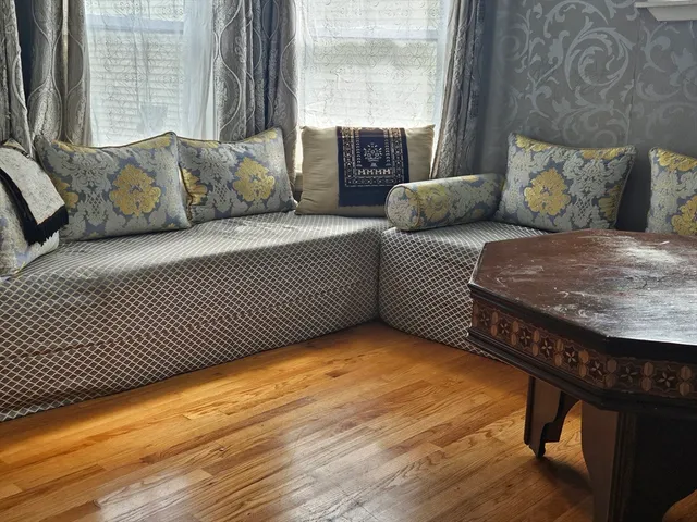 a bedroom with furniture and a large window