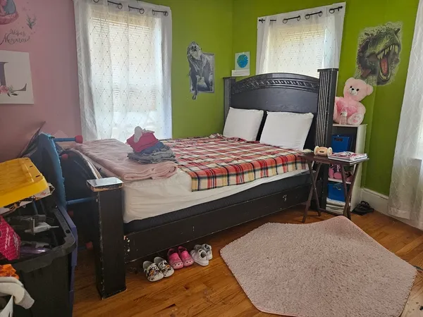 a bed sitting in a bedroom next to a window