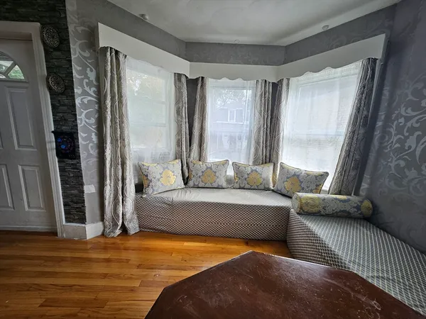 a bedroom with furniture and a window