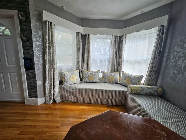 a bedroom with furniture and a window