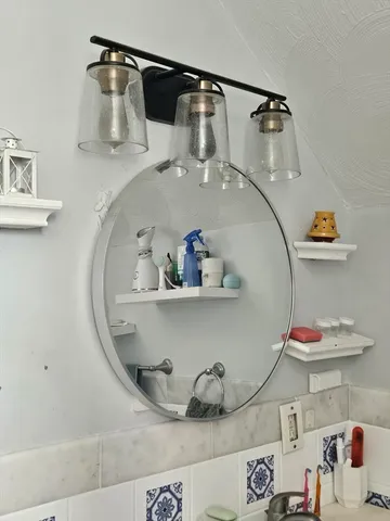 a close view of light fixtures and a mirror on the wall