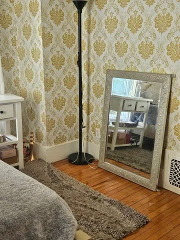 a bedroom with a bed and a mirror