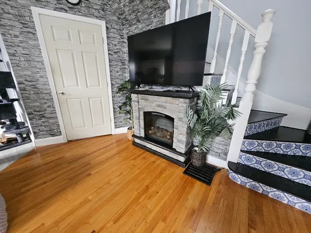 a living room with a flat screen tv and a fireplace