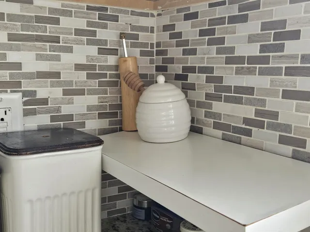 a close view of a sink a stove and a microwave