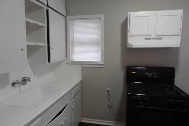 8706 Cardella Avenue Dallas, TX 75217 - Photo 5 of 8 a bathroom with a sink and a mirror
