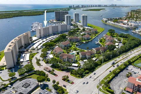 an aerial view of a house with a yard and lake view