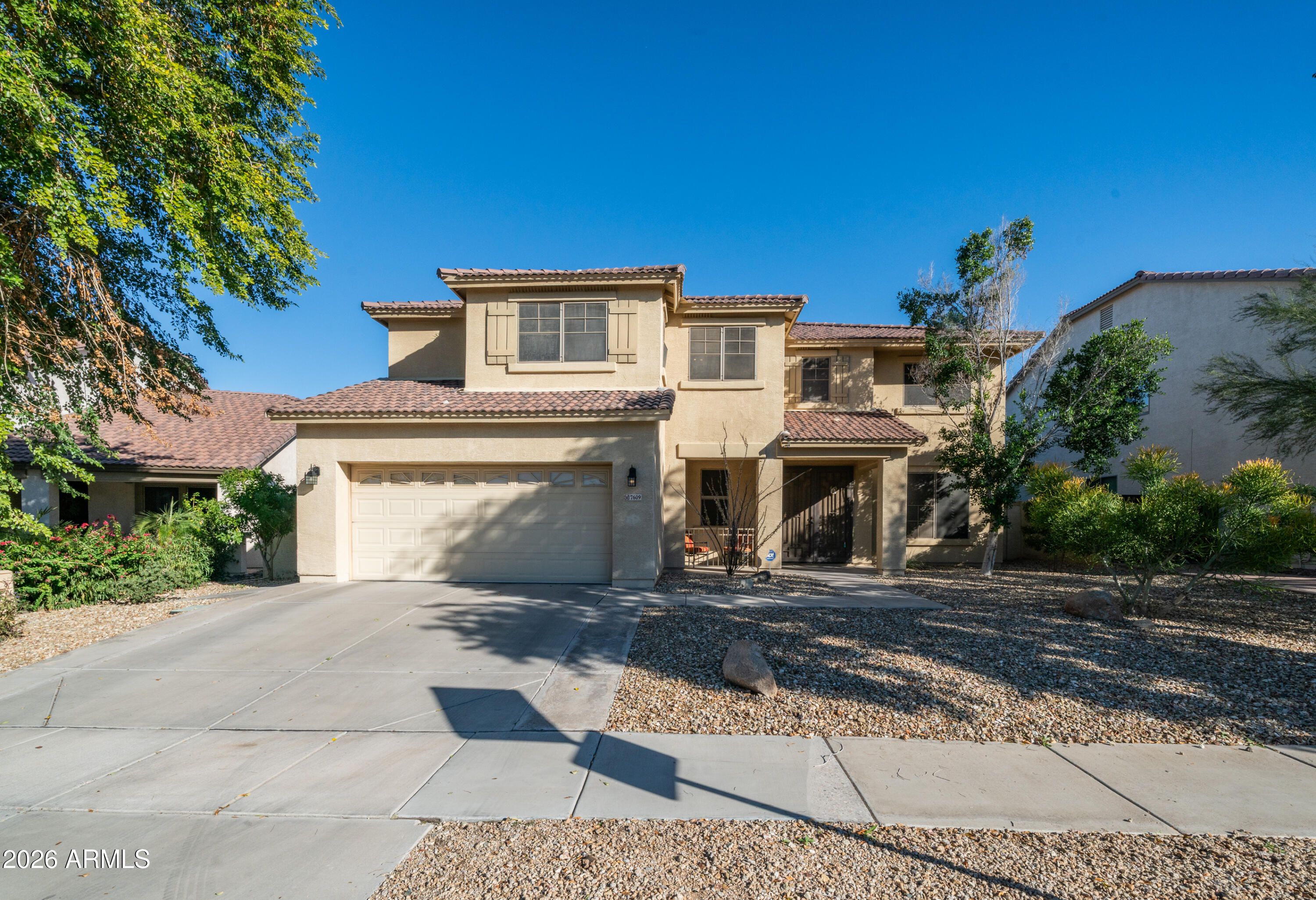 7609 South 18th Way Phoenix, AZ 85042 - Photo 1 of 32 a front view of a house with a yard