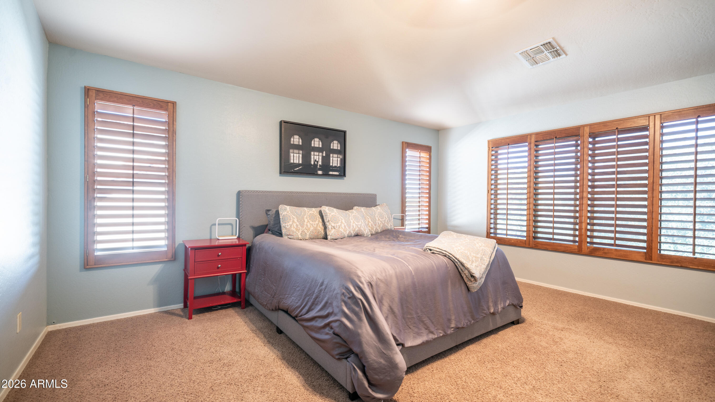 7609 South 18th Way Phoenix, AZ 85042 - Photo 16 of 32 a spacious bedroom with a bed a closet and a window