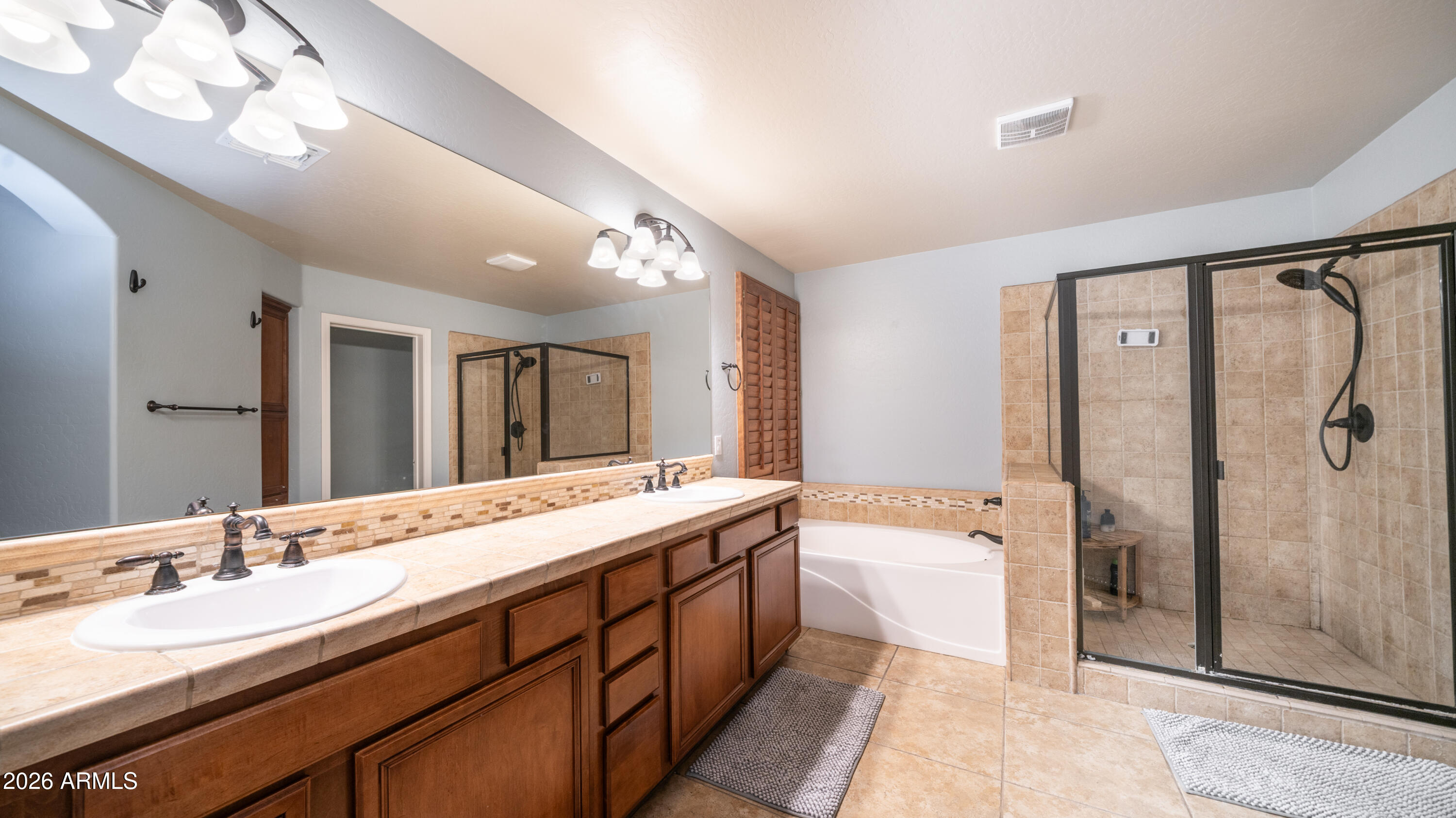 7609 South 18th Way Phoenix, AZ 85042 - Photo 18 of 32 a spacious bathroom with a double vanity sink mirror double and shower