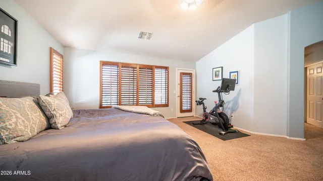 a bedroom with a bed and a large window