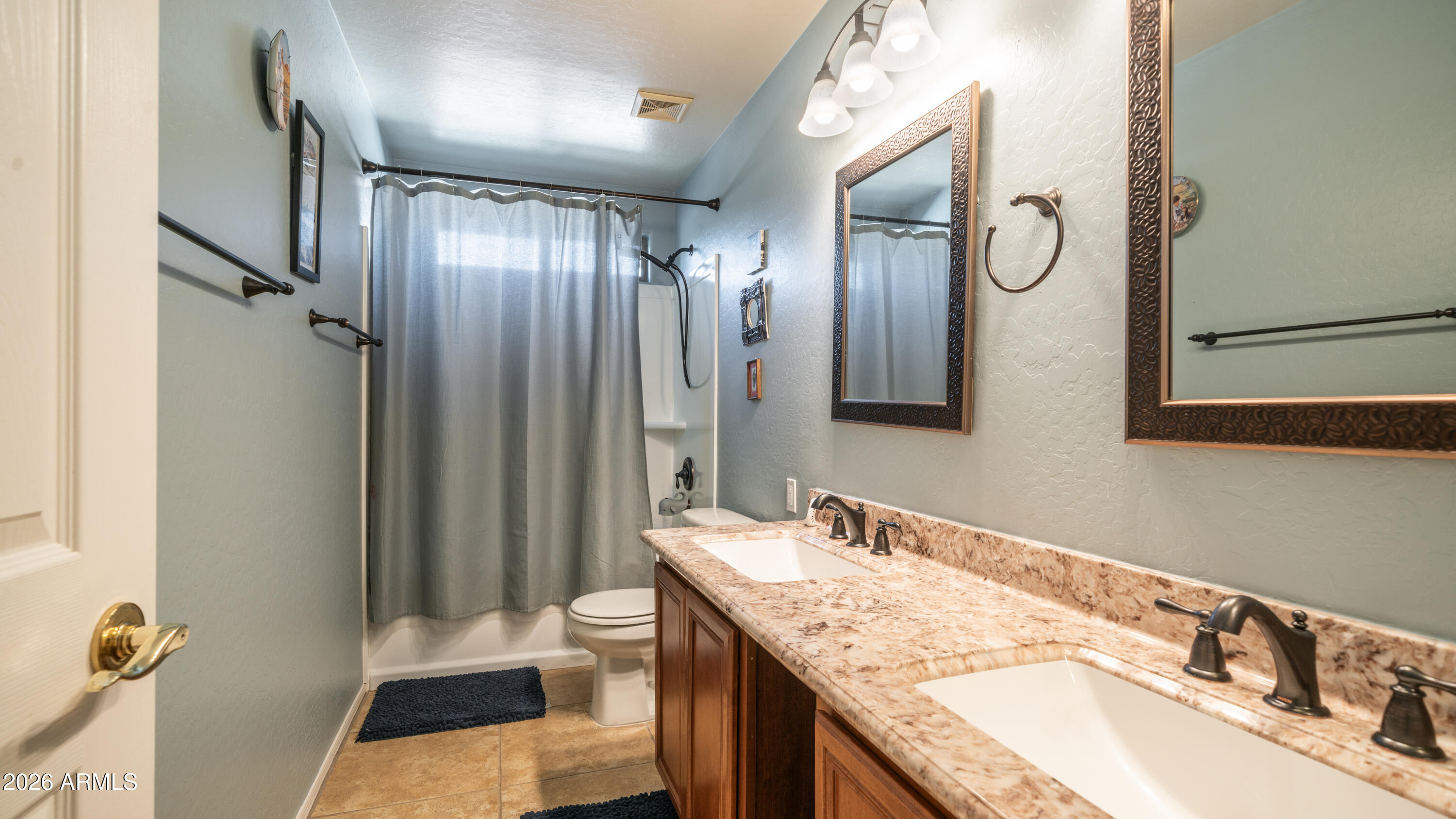 7609 South 18th Way Phoenix, AZ 85042 - Photo 22 of 32 a bathroom with a granite countertop double vanity sink mirror and toilet