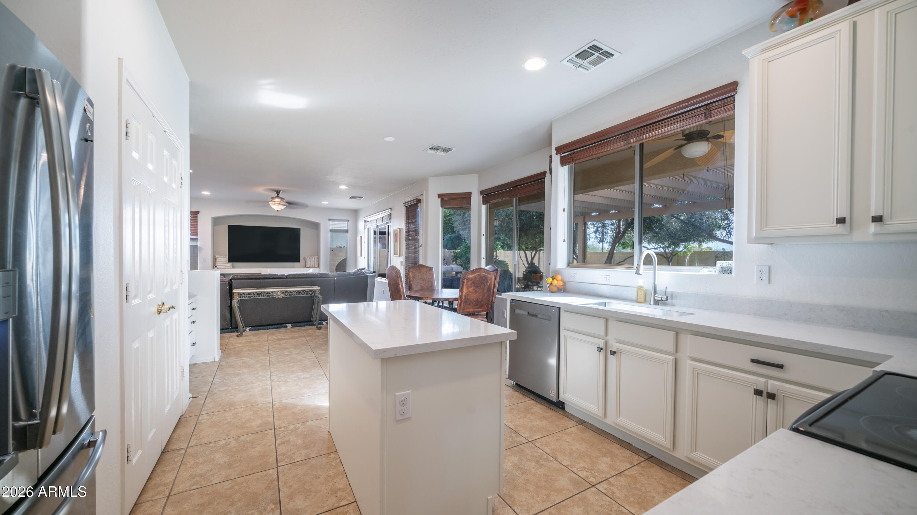 7609 South 18th Way Phoenix, AZ 85042 - Photo 6 of 32 a large kitchen with kitchen island a sink stainless steel appliances and cabinets