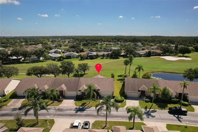 an aerial view of houses with yard