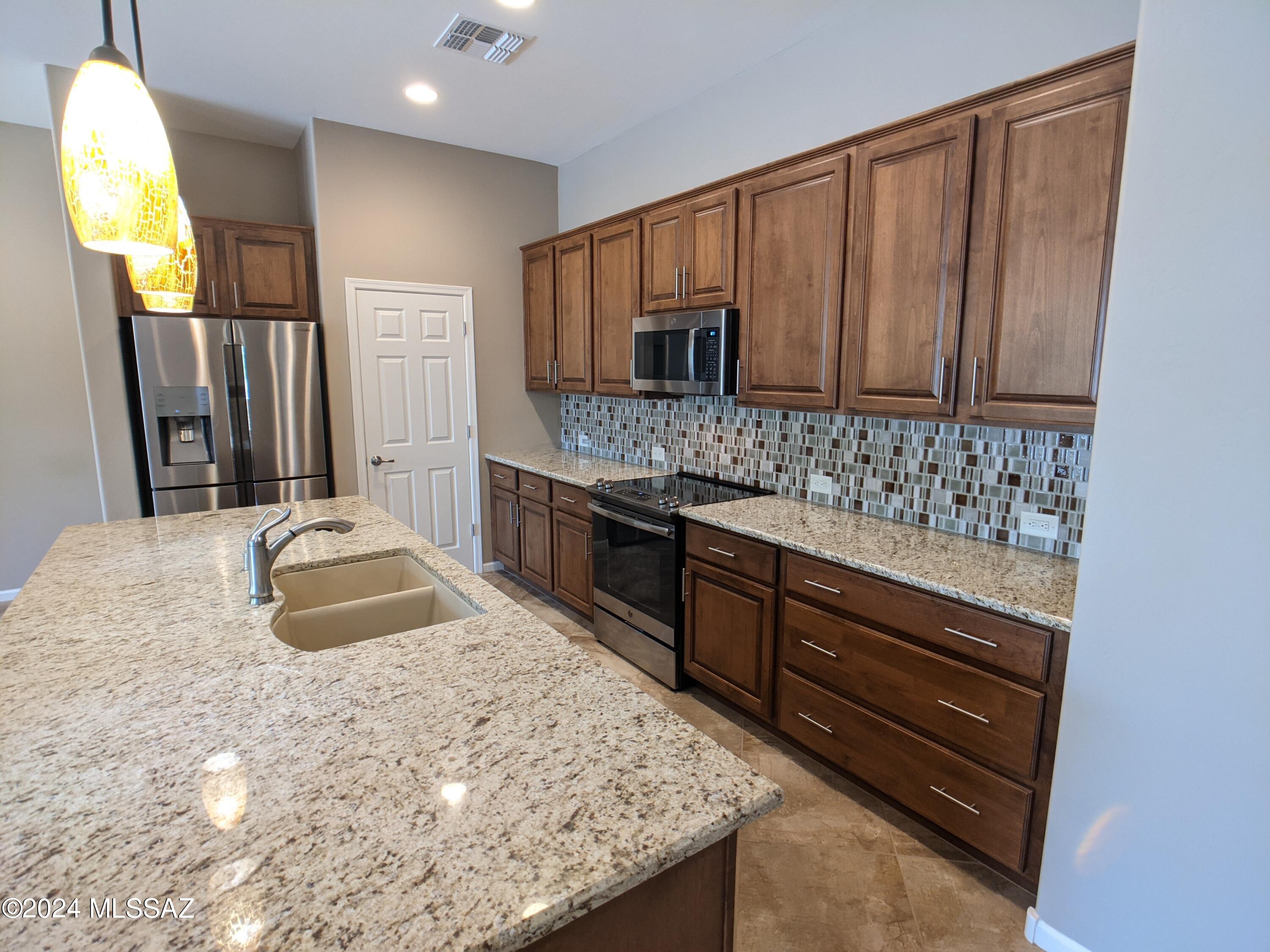 61021 East Slate Road Oracle, AZ 85623 - Photo 6 of 18 a bathroom with a granite countertop sink and a mirror