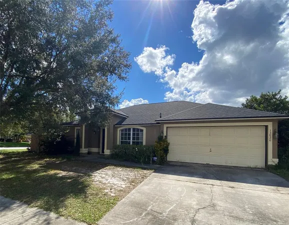 a front view of a house with a yard and a garage