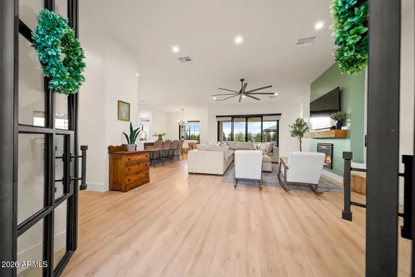 a living room with furniture a fireplace and a chandelier
