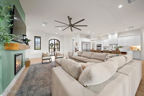 a large living room with stainless steel appliances granite countertop a couch and a flat screen tv