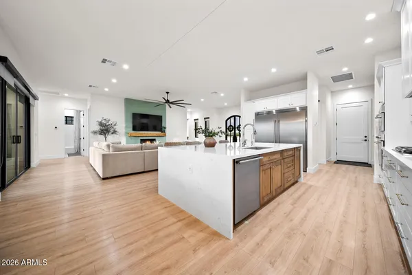 a kitchen with granite countertop white cabinets and white appliances
