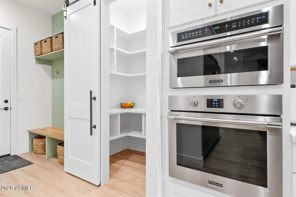 a spacious bathroom with a double vanity sink a mirror and a shower