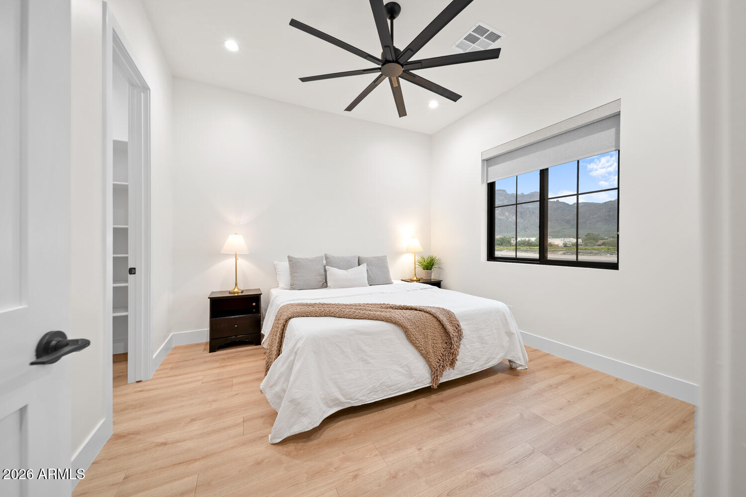 590 South Sun Road Apache Junction, AZ 85119 - Photo 39 of 68 a bedroom with a large bed and a chandelier