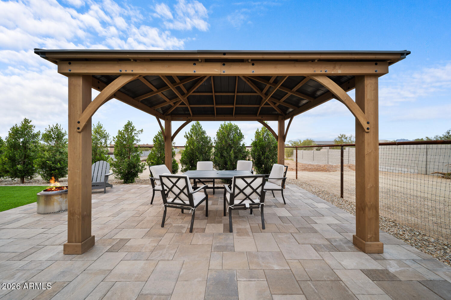 590 South Sun Road Apache Junction, AZ 85119 - Photo 58 of 68 a view of patio with table and chairs under an umbrella with a barbeque