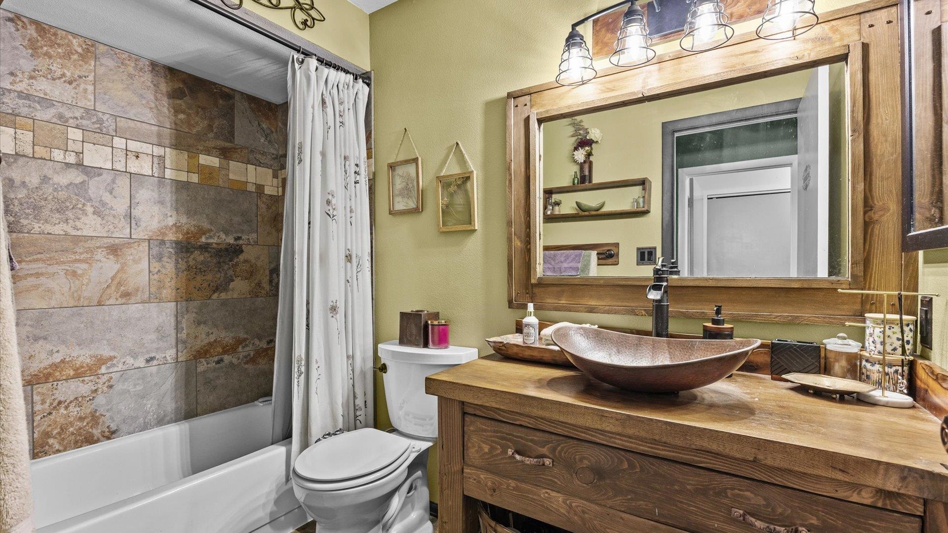517-28 28 1/2 Road, Unit 4E Grand Junction, CO 81501 - Photo 10 of 15 a bathroom with a granite countertop sink toilet a mirror and shower