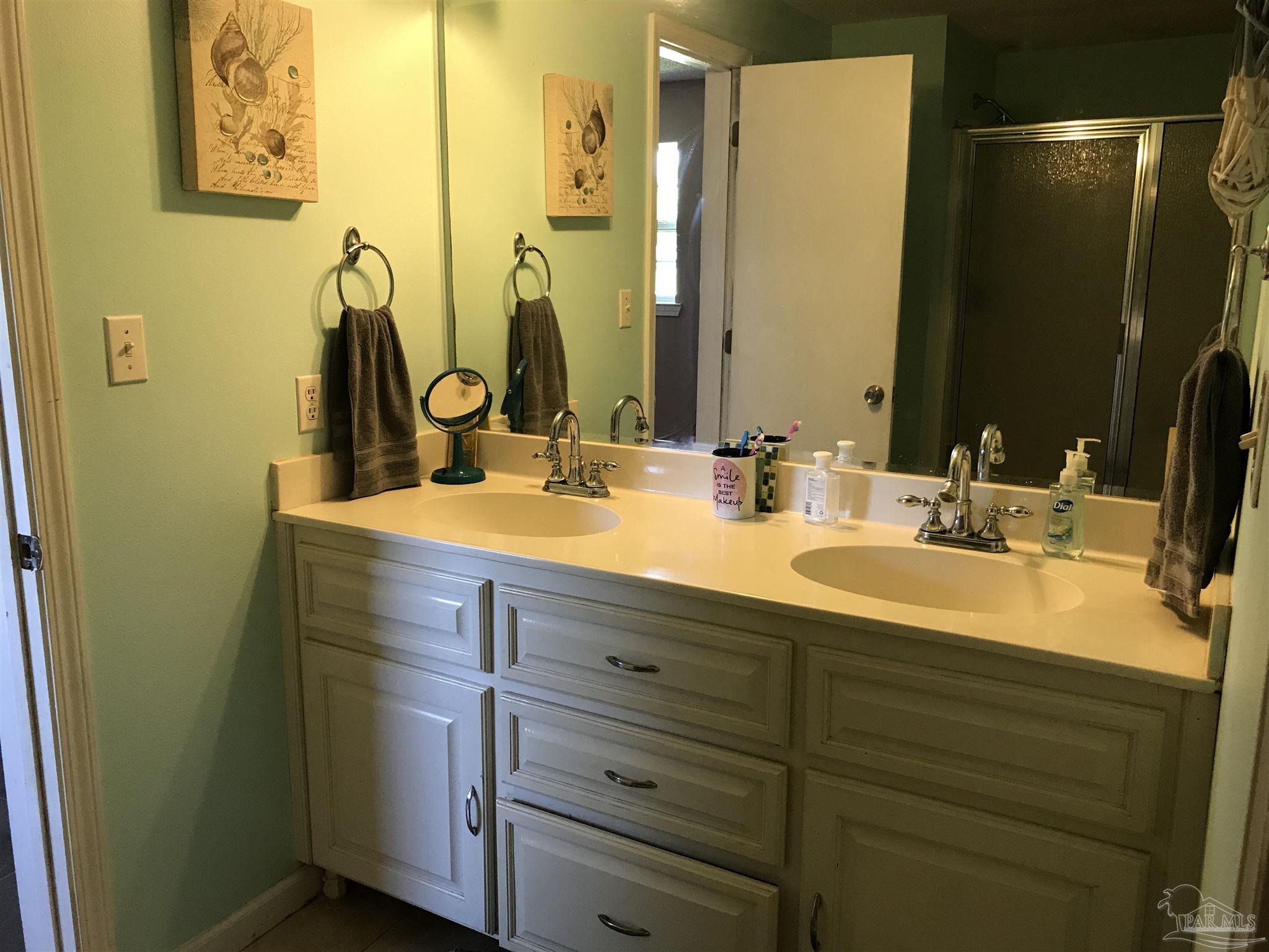2529 Molino Road Molino, FL 32577 - Photo 21 of 43 a bathroom with a double vanity sink and a mirror