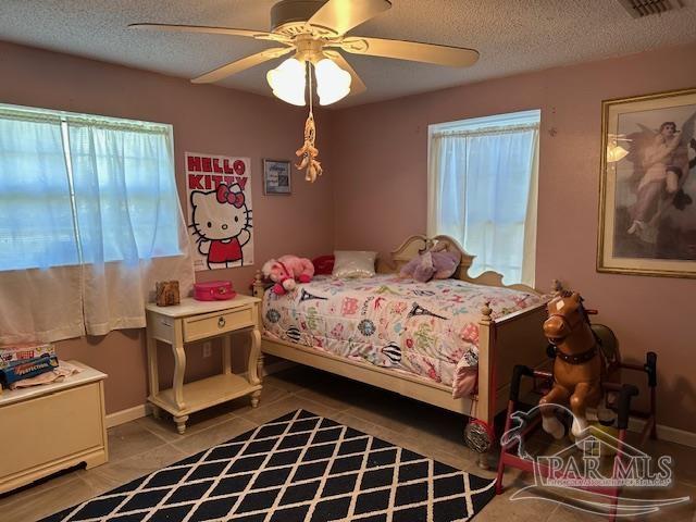 2529 Molino Road Molino, FL 32577 - Photo 24 of 43 a bedroom with a bed and a chandelier