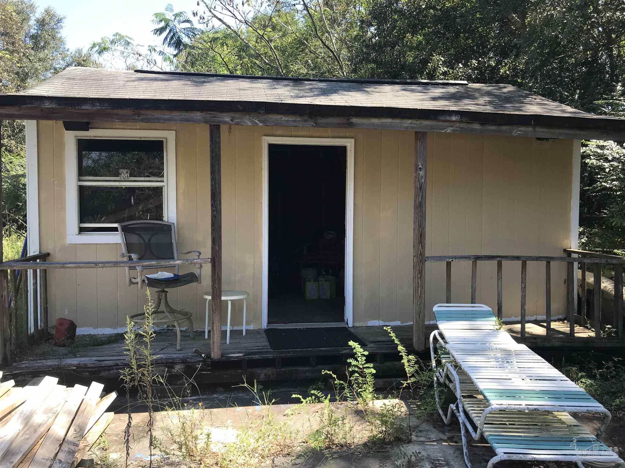 2529 Molino Road Molino, FL 32577 - Photo 41 of 43 a view of a patio with table and chairs with wooden floor and fence