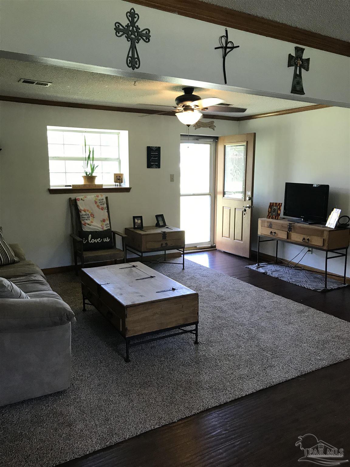2529 Molino Road Molino, FL 32577 - Photo 9 of 43 a living room with furniture and a flat screen tv