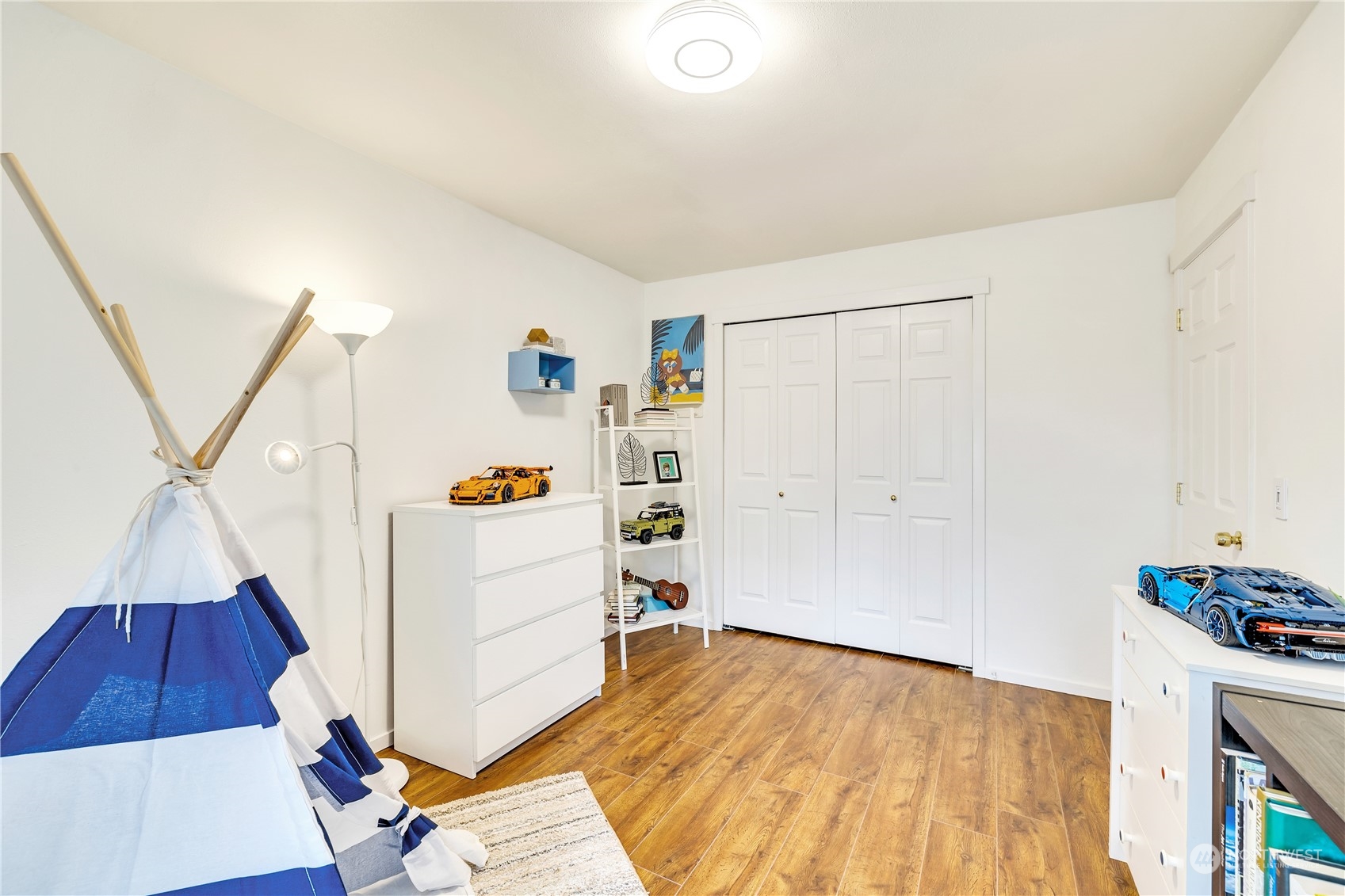 14401 Southeast Petrovitsky Road, Unit B101 Renton, WA 98058 - Photo 13 of 22 a view of a kitchen with furniture and wooden floor