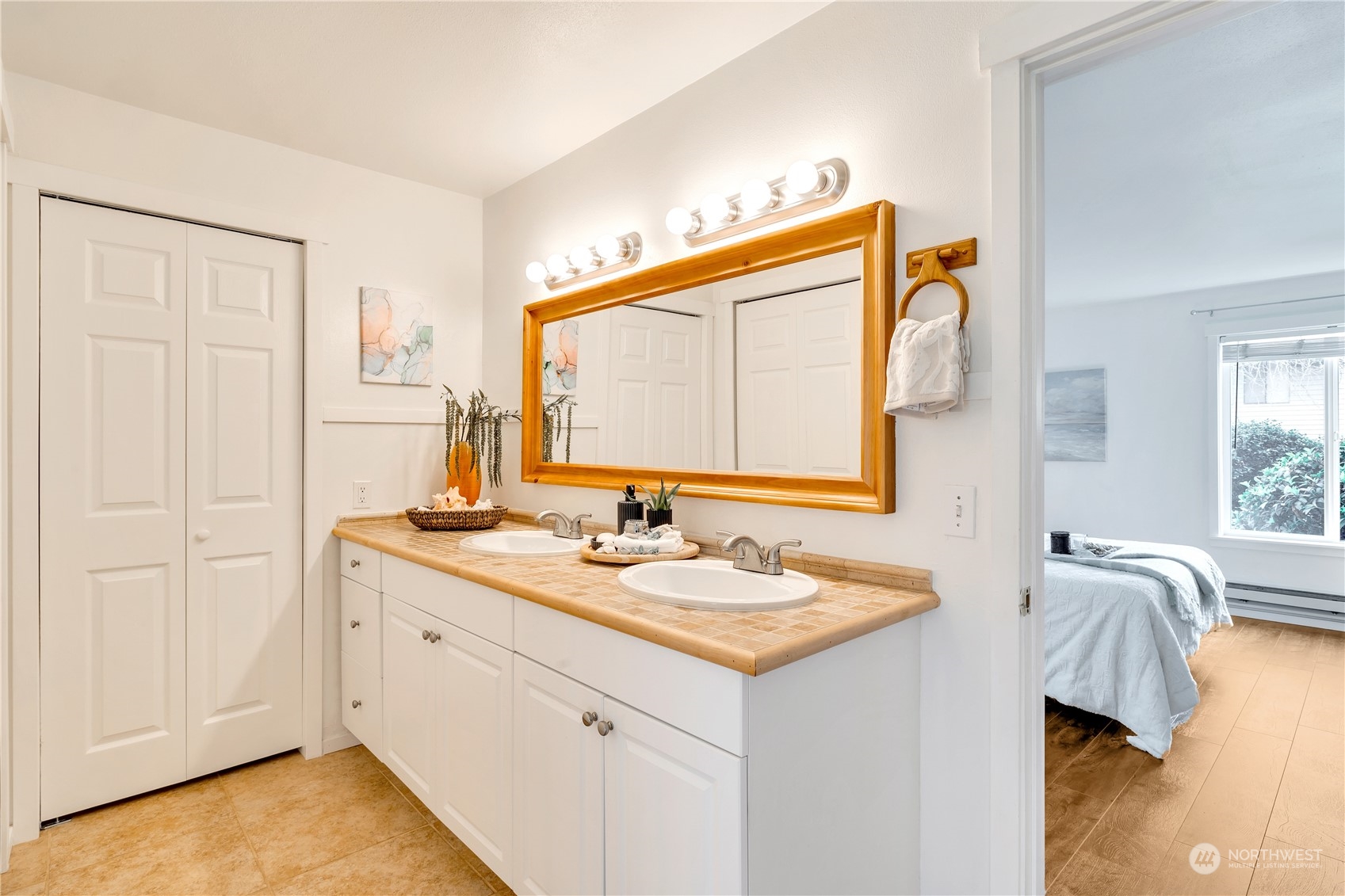 14401 Southeast Petrovitsky Road, Unit B101 Renton, WA 98058 - Photo 18 of 22 a en suite bathroom with a sink and a mirror