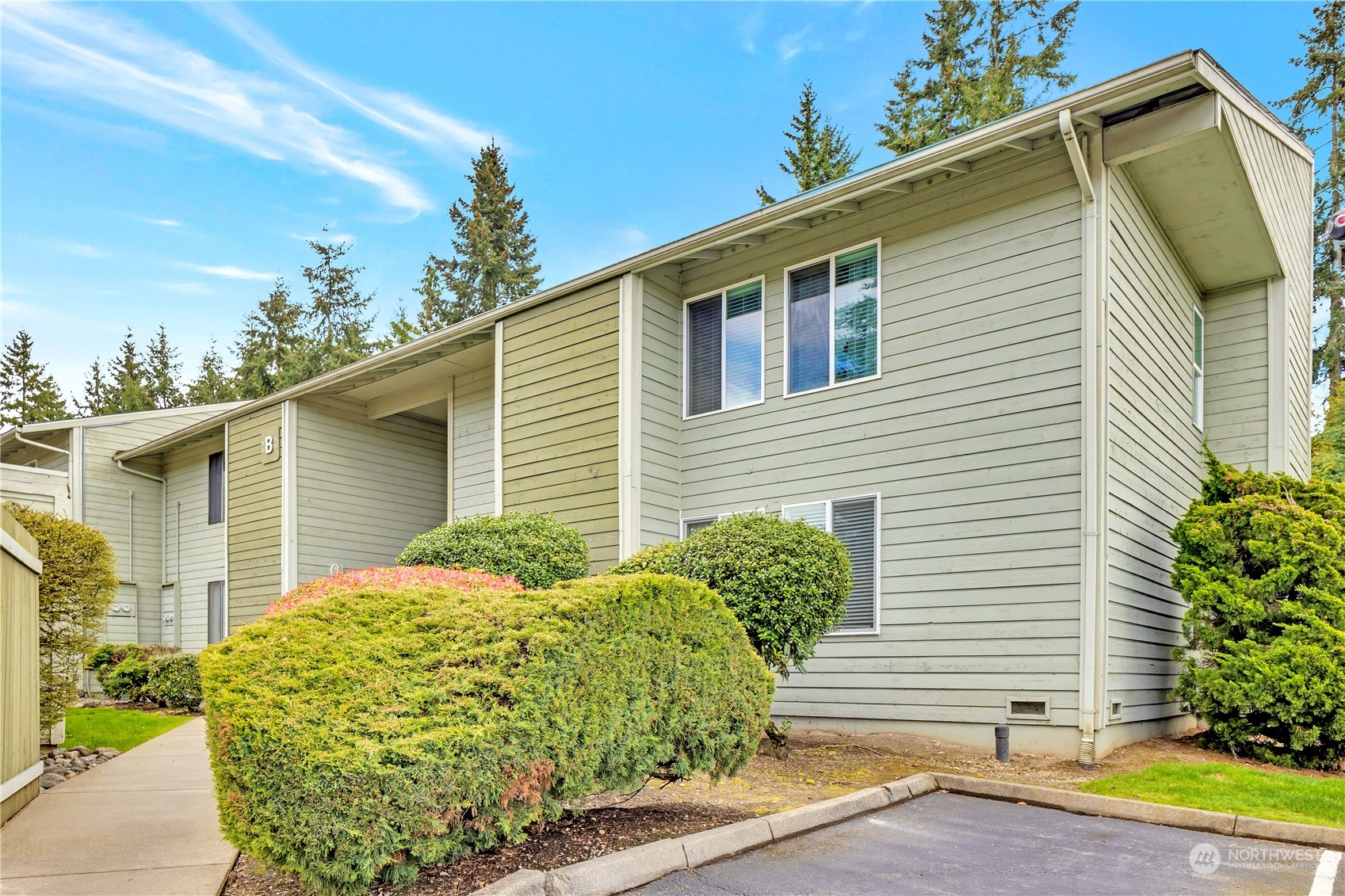 14401 Southeast Petrovitsky Road, Unit B101 Renton, WA 98058 - Photo 22 of 22 a backyard of a house with plants and trees