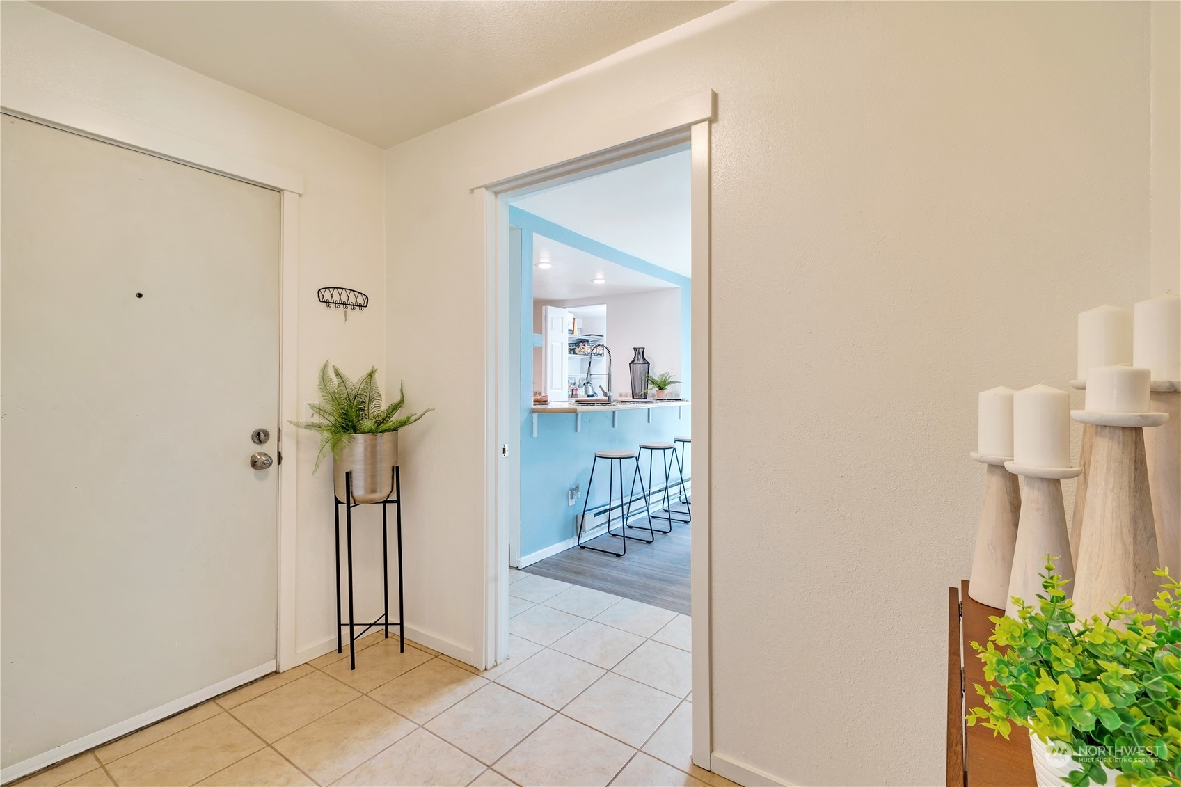 14401 Southeast Petrovitsky Road, Unit B101 Renton, WA 98058 - Photo 6 of 22 a view of a hallway with wooden floor and a dining room