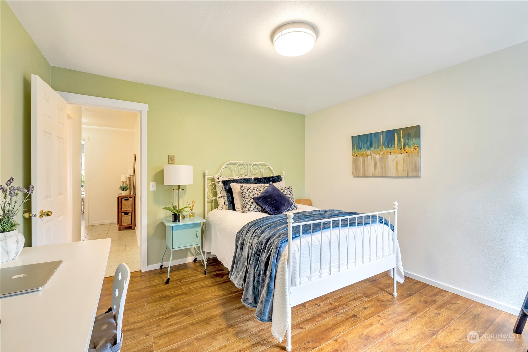 14401 Southeast Petrovitsky Road, Unit B101 Renton, WA 98058 - Photo 9 of 22 a bedroom with a bed and wooden floor