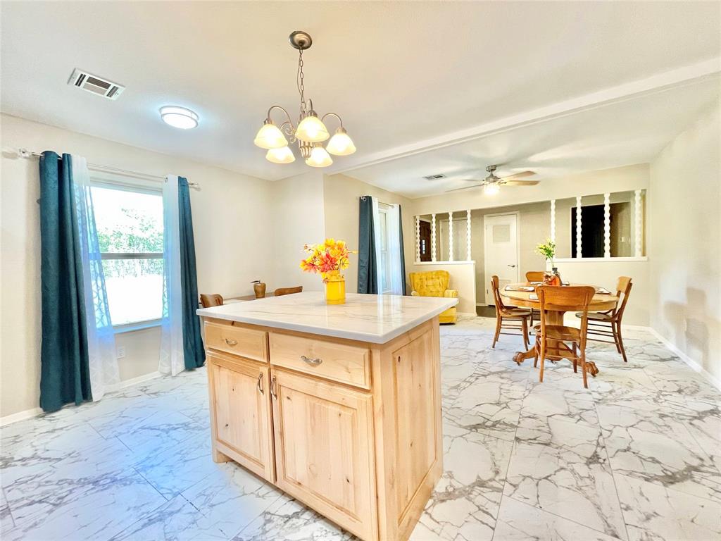945 Brickyard Road West, TX 76691 - Photo 11 of 25 a view of a dining room and kitchen with a chandelier