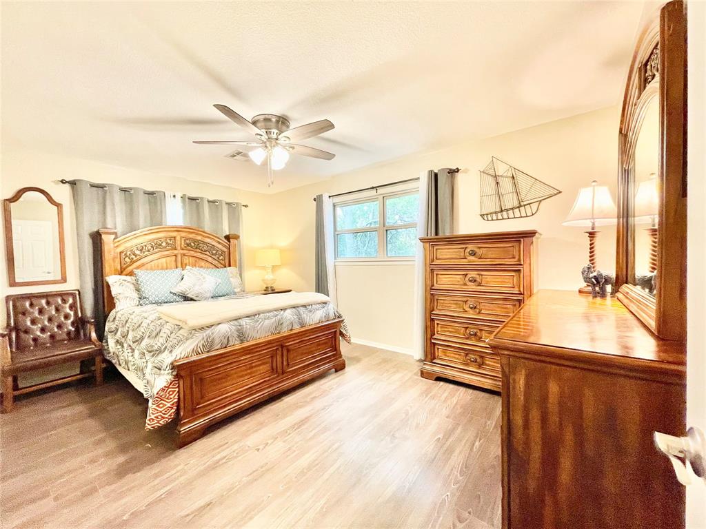 945 Brickyard Road West, TX 76691 - Photo 13 of 25 a bedroom with a bed dresser and a window