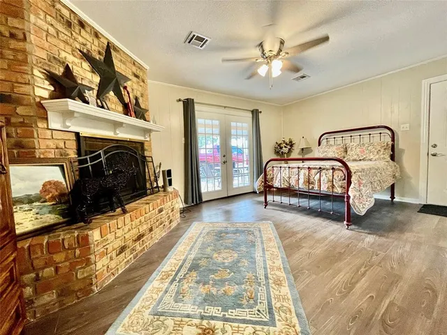 a spacious bedroom with a bed and a fireplace