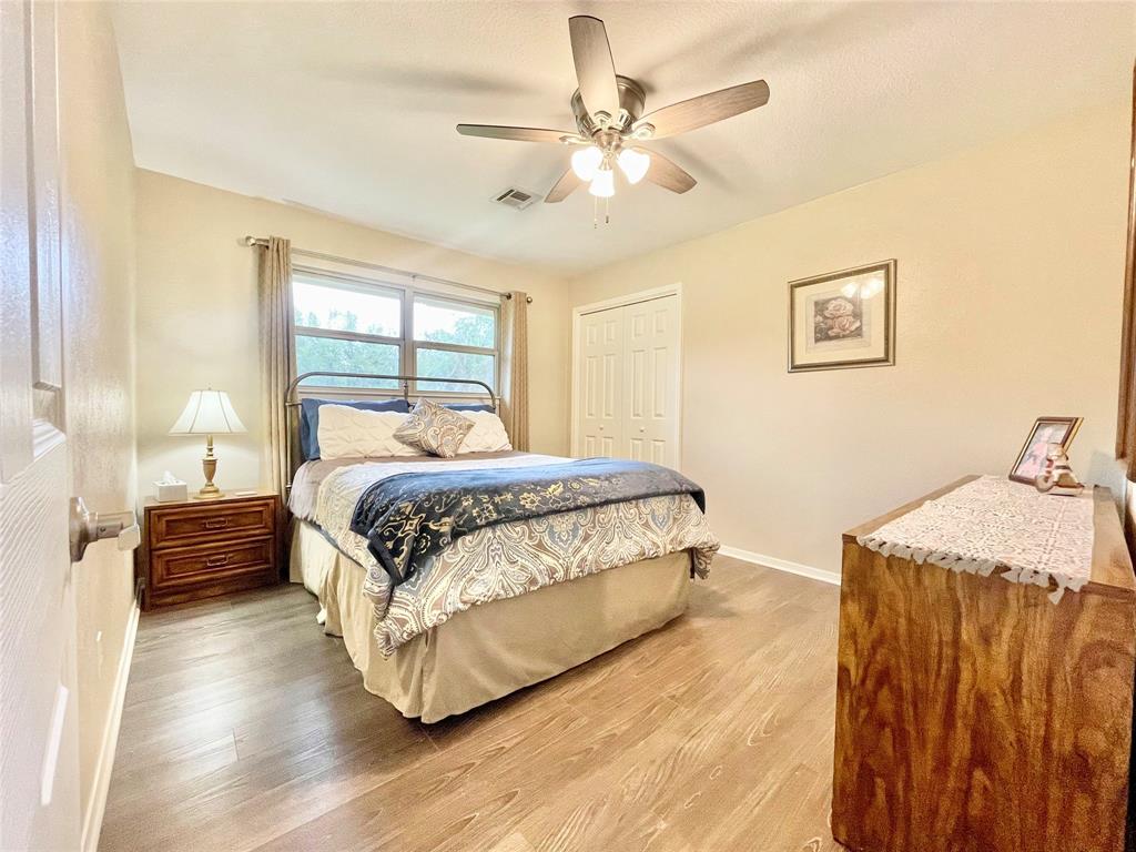 945 Brickyard Road West, TX 76691 - Photo 19 of 25 a bedroom with a bed and wooden floor