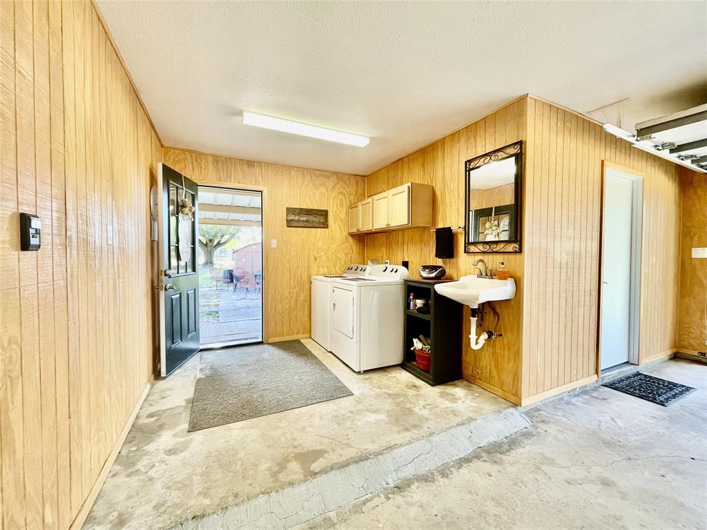 945 Brickyard Road West, TX 76691 - Photo 20 of 25 a view of a kitchen with a sink and dishwasher with wooden floor