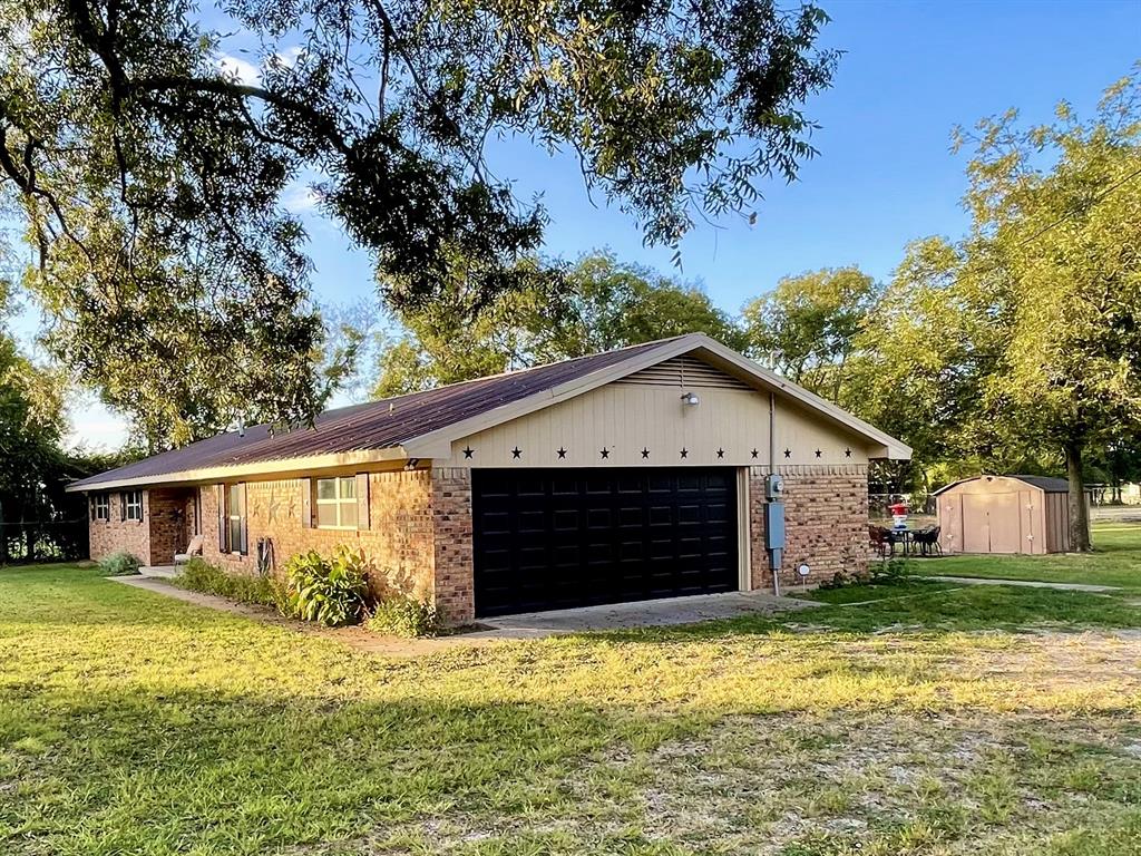 945 Brickyard Road West, TX 76691 - Photo 3 of 25 a front view of house with yard and trees in the background