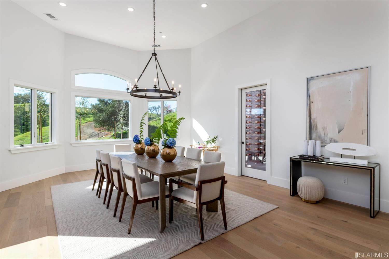 5 Winding Oaks Drive Pleasanton, CA 94566 - Photo 18 of 72 a dining room with wooden floor a chandelier a wooden table and chairs